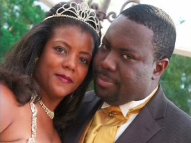 Angela in a tiara and David in a gold tie, cheek to cheek on their wedding day